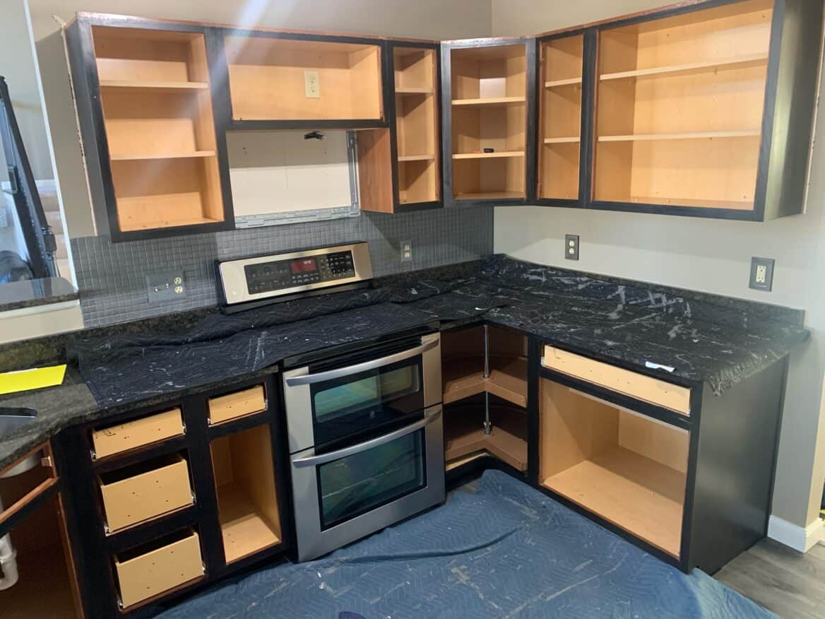 black kitchen cabinets with the doors removed