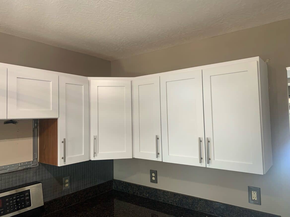 White kitchen cabinet doors with brand new silver hardware.